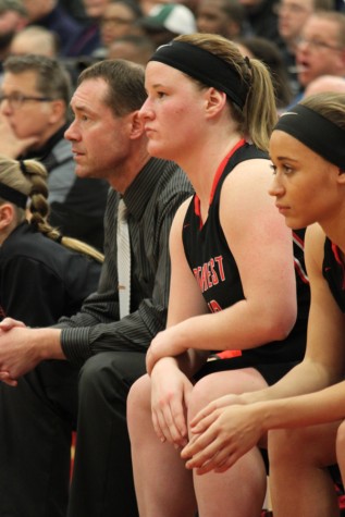 Assistant Coach Mr. Jason Khon and seniors Sarah Gwinn and Tyriah Pryor watch from the sidelines.