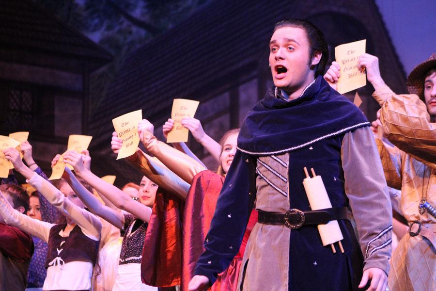 Senior Colin Dexter, as Lord Pinkleton, announces to the cast, as townspeople, that the prince is giving a ball in order to find a bride.