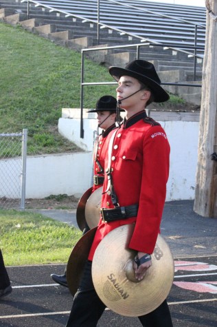 Junior Lee Belding is marching with his symbols before a football game