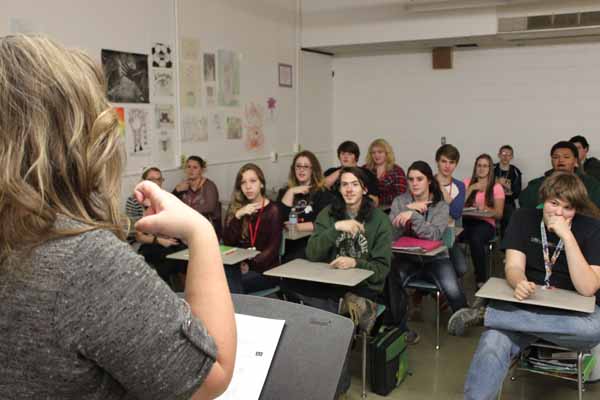 American Sign Language teachers Ms. Maxwell review and act out sign language with her class.  