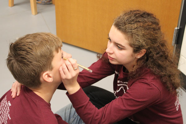  Sophomore Chris Boyer is helped with makeup by  Sophi Epstein.