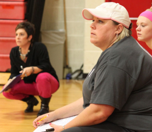 Head coach Amanda Anspaugh (left) and assistant coach Debbie Bevier (right) look on as their team plays a match at Vandercook high school.