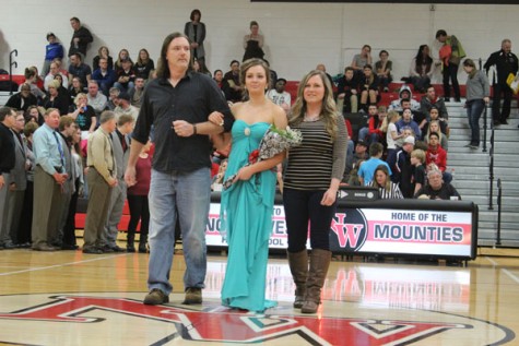 Freshman Jessica Piotrowski walking with her parents as a member of Snowfest Court 2016.