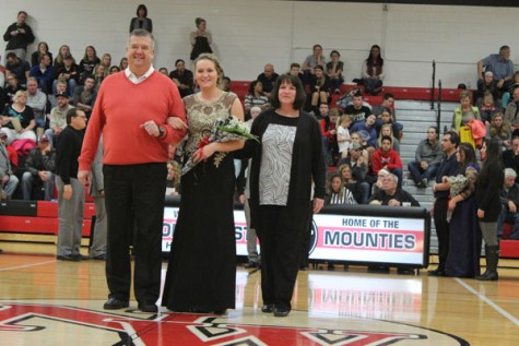 Sophomore Sami Peters walking with her parents as a member of Snowfest Court 2016.