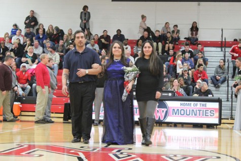 Junior CeCe Klee walking with her parents as a member of Snowfest Court 2016.
