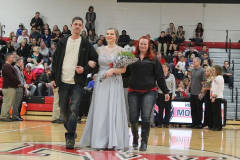 Senior Shai Case walking with her parents as a member of Snowfest Court 2016.
