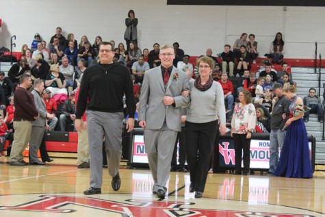 Senior Nathaniel Berry walking with his parents as a member of Snowfest Court 2016.