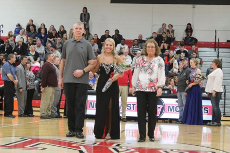Senior Sierra Divish walking with her parents as a member of Snowfest Court 2016.