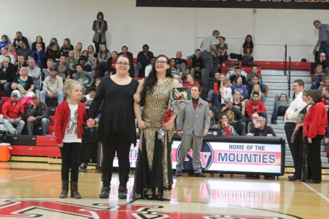 Senior Gabrielle Streeter walking with her mother and sister as a member of Snowfest Court 2016.