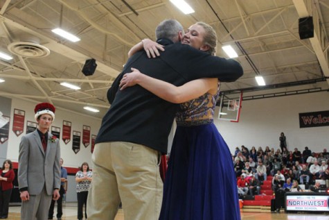 Principal Scott Buchler congratulating senior Madison Perrin on becoming Snowfest Queen.