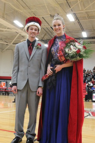 Seniors Jacob Phelan and Madison Perrin posing for a picture as Snowfest King and Queen at boys basketball game against Marshall.