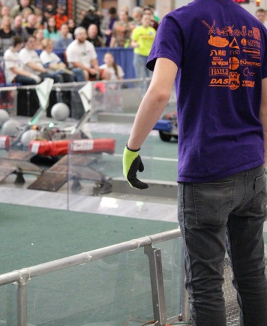Senior Aaron Heath is spying to the drive team to direct the robot.