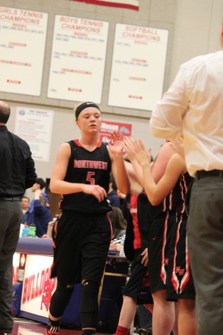 Sophomore Ella Bontrager high-fives her teammates after being rotated out.