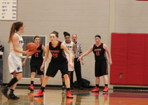 The Varsity Girls Basketball team cover senior Taryn McCutcheon from East Lansing.