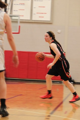 Senior Lexie Khon dribbles the ball in the perimeter.