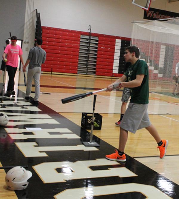 Freshman Sawyer Epstein practices swinging his bat.