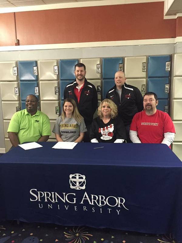 Senior Kelsey Thomas being supported by her parents, high school coaches, and college coach at her signing.
