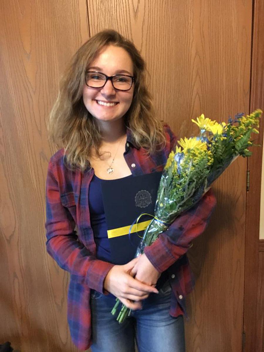 Senior Hailey Baker holds the flowers she was given from SAU. 