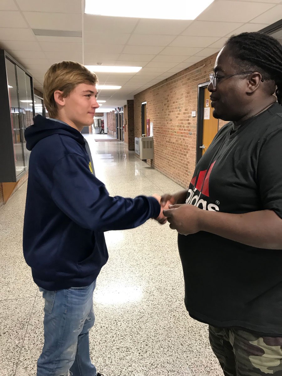 During classes Hardrick checks the halls to be sure all students not in class have passes to be out. Freshman Conner Romm shakes Hardricks hand after showing Hardrick his pass to be out of class.