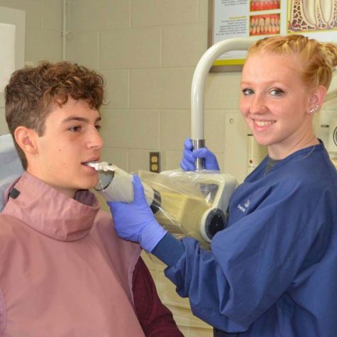 Senior Amber Carroll practices positioning the x-ray and taking x-rays on a classmate.