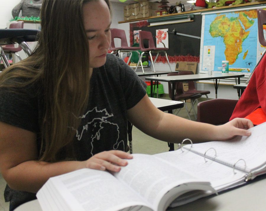Senior Madelyn Miller reviews notes for AP US History before the class period begins.