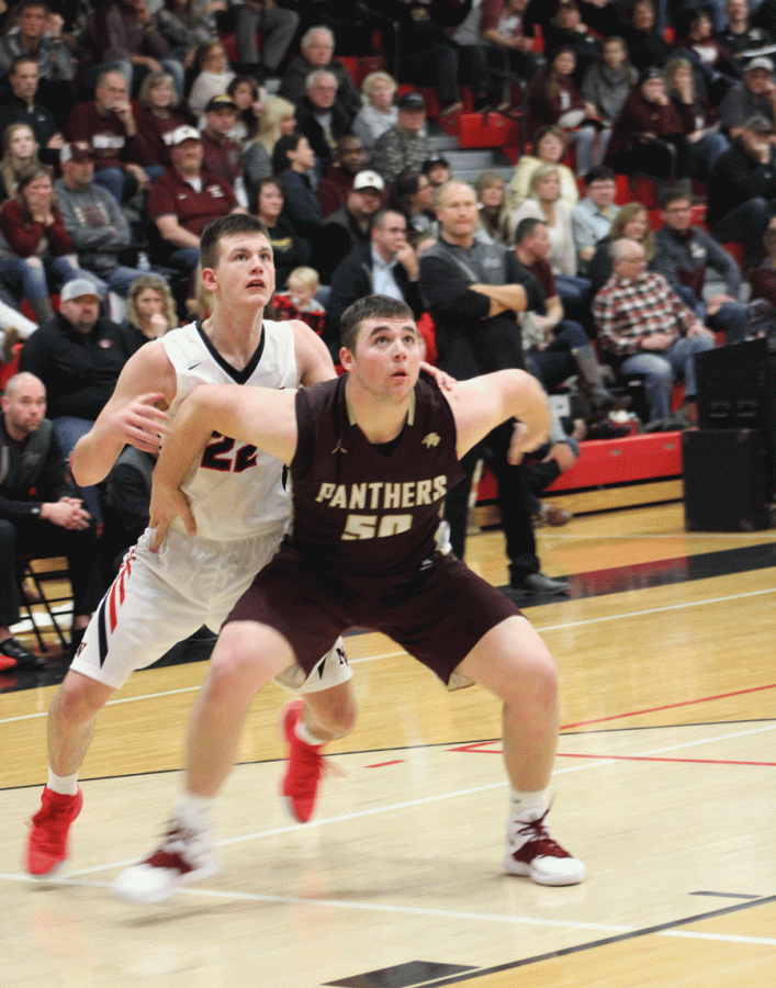 Andrew Green fights around a tough box out from an opposing defender.