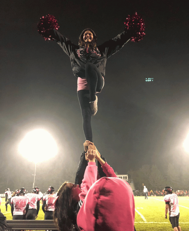Senior Arianna Trine performs at the pink out game at Leslie.