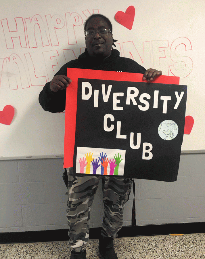 Hall+monitor+Mr.+Gregory+Hardwick+holds+a+sign+that+represents+the+Diversity+Club.