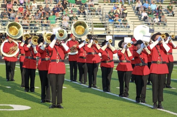 Playing loud for all to hear, the Marching Mounties preform at a Friday night football game.