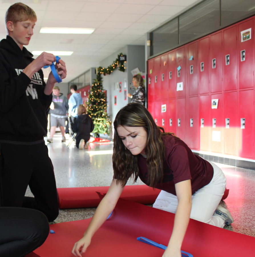 Brooke Barret and Hudson Cooper taping pieces for the Polar Express train.