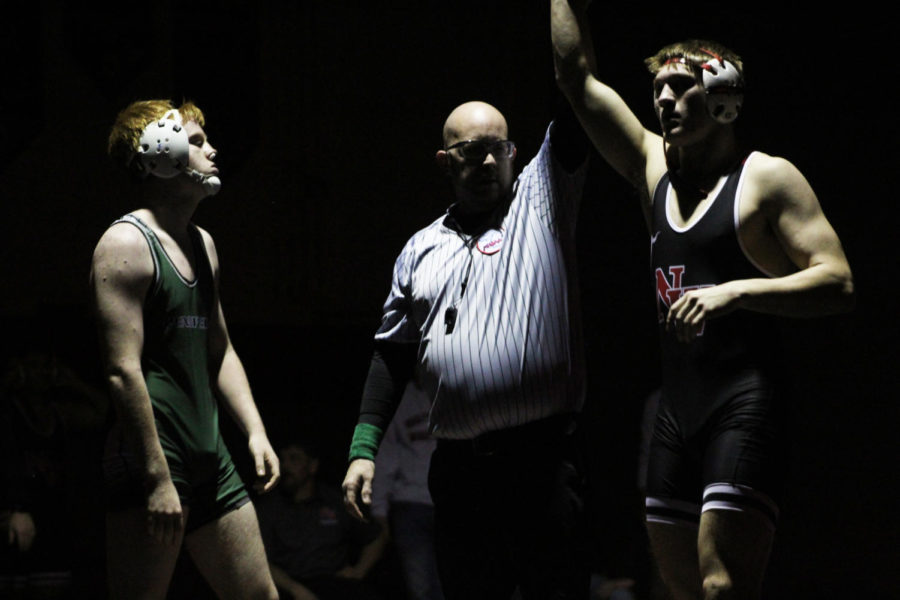 Overcome with competitive joy, Junior Adam Haselius defeats division team Pennfield.