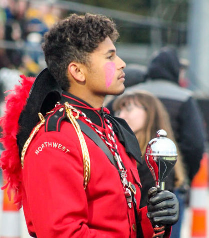 Senior Drum Major Marcus Arbrouet awaits patiently as he and the band will rush onto the field to preform their halftime show. 