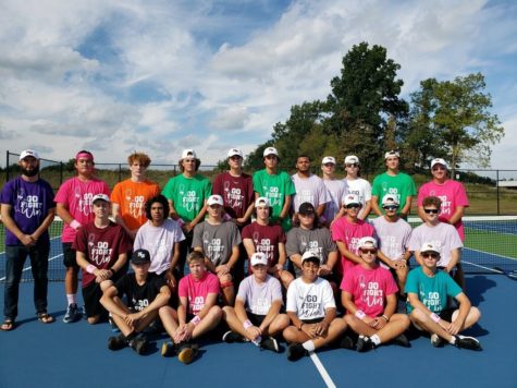 The Boys Tennis team posing for a picture before their cancer awareness game vs Hastings. 
