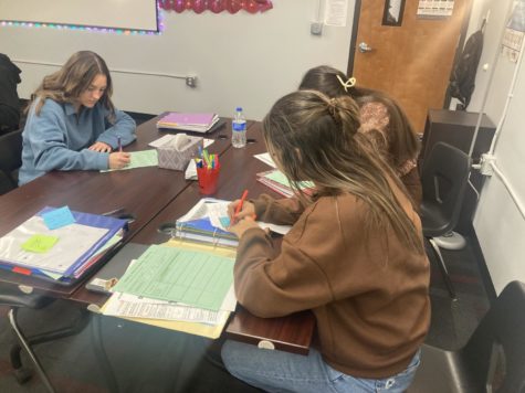 Three student completing work in Mrs.Bortnichaks AP Language class