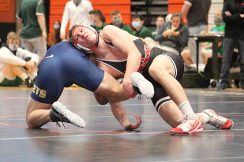 Senior Adam Haselius competing in a match last season. This is the same year he won the state title. 