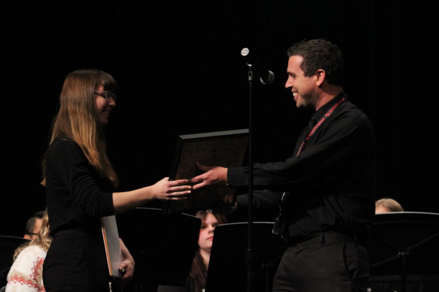 Miss Mills receiving a shadow box from Director Bryan Mangiavellano