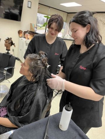 Senior Kyleigh Tindall works with a customers hair while learning at the career center.