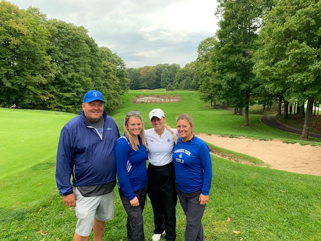 Lefere standing with her family on their golf course. 