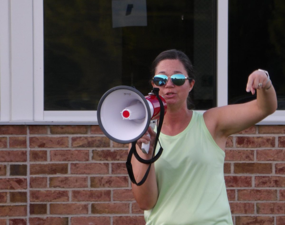 Mrs. Alexander directing the color warriors on where the border of the battlefield is. 