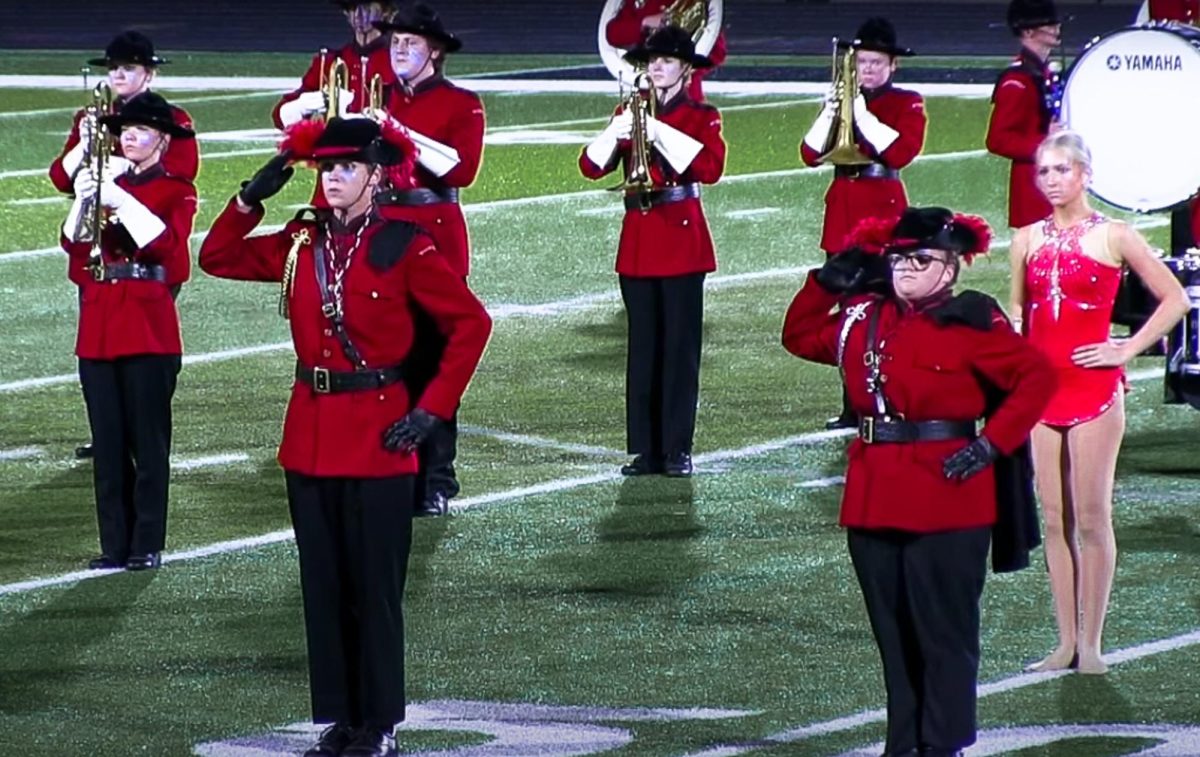 Drum Majors Will Atwood and Lily Affarano salute before the band performs.