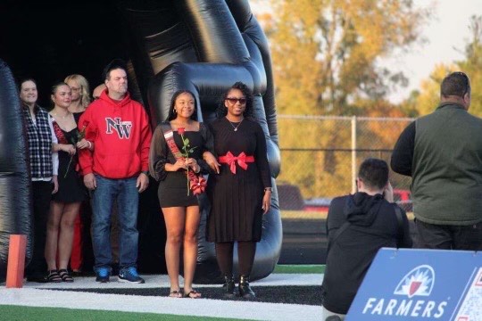 Ka’Tasia Brown and her Aunt Angelica Wilson walking down the field together.