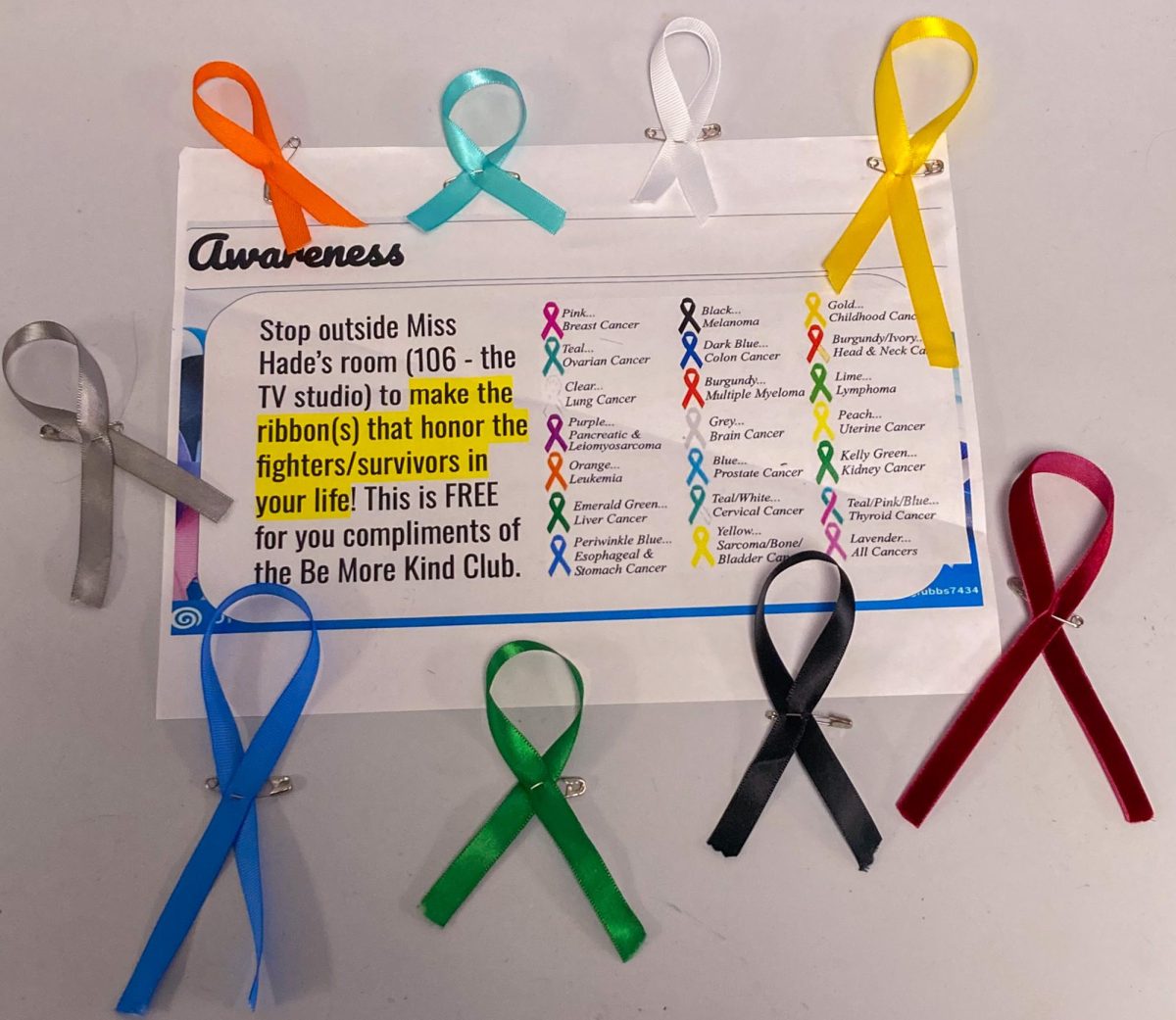 A sign promoting the cancer awareness ribbon station.