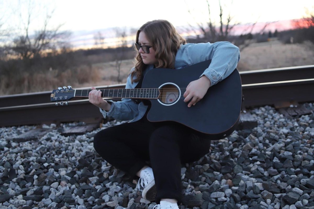 Lilianna Affarano playing guitar.