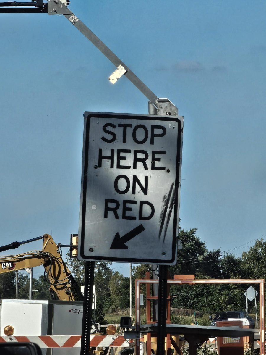 Road sign telling drivers to stop and wait on red