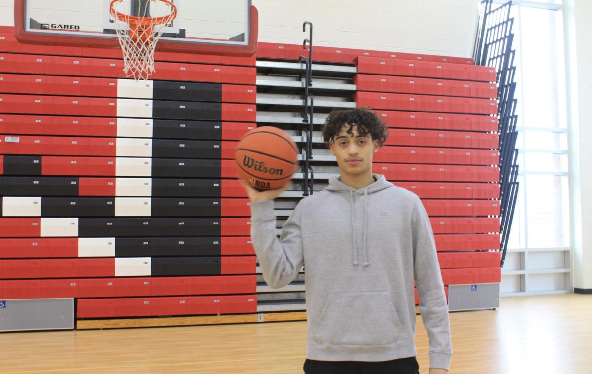 Roe-Darrel DeDeaux holds a basketball.